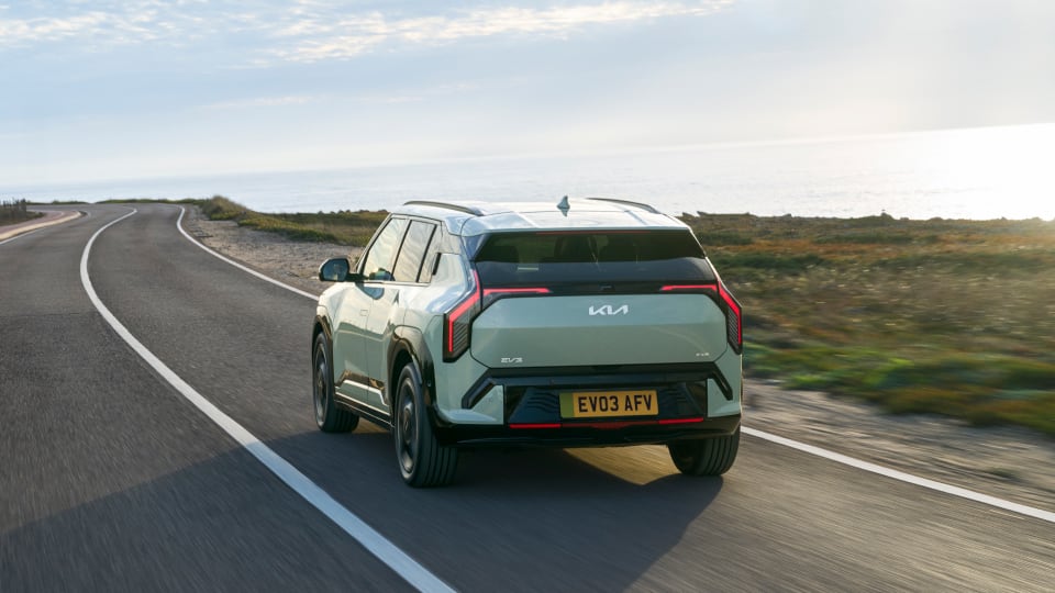Rear angled view of Kia EV3 on road